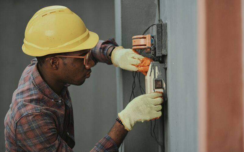 Engineer in a hard hat working on electrical installation